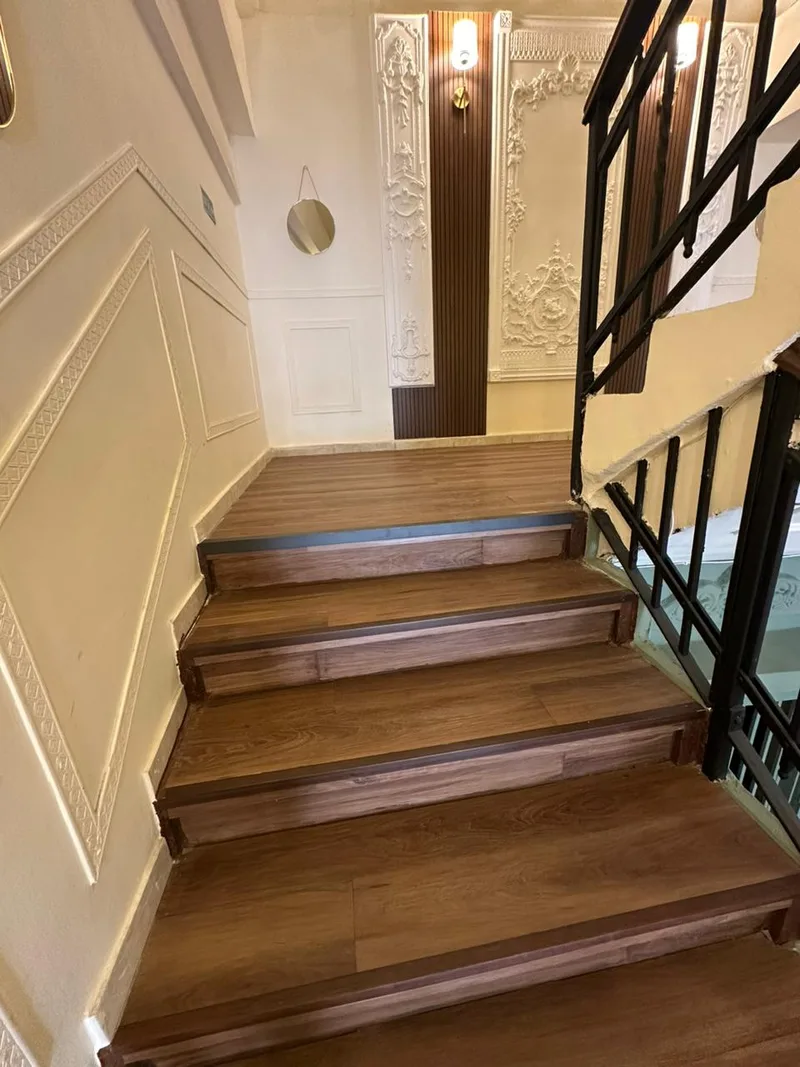 Moulded plaster panels along the stair